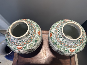 A pair of Chinese famille verte 'bird and flower' vases and covers, Kangxi mark, 19th C.