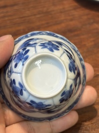 Four Chinese blue and white saucers and an 'erotic' cup, Kangxi