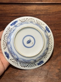 A Chinese blue and white reticulated double-walled cup and saucer, Kangxi