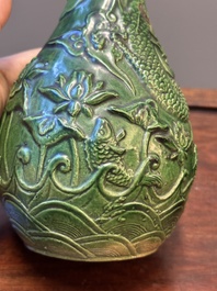 Two Chinese monochrome green-glazed stoneware 'dragon' vases and a kendi, Fujian kiln, late Ming