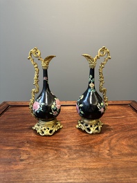 A pair of Chinese black-ground famille rose vases with gilt bronze mounts, Yongzheng