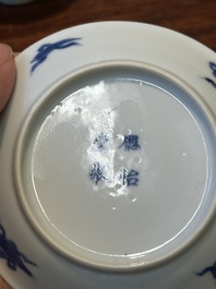 Four Chinese blue and white saucers and an 'erotic' cup, Kangxi