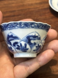 Four Chinese blue and white saucers and an 'erotic' cup, Kangxi