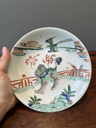 A Chinese famille verte 'qilin and falcon' plate, artemisia leaf mark, Kangxi