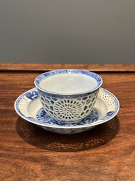 A Chinese blue and white reticulated double-walled cup and saucer, Kangxi