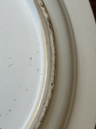 A Chinese blue and white dish with landscape and floral panels, Kangxi