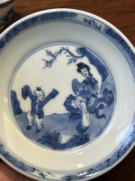 Four Chinese blue and white saucers and an 'erotic' cup, Kangxi