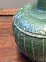 Two Chinese monochrome green-glazed stoneware 'dragon' vases and a kendi, Fujian kiln, late Ming