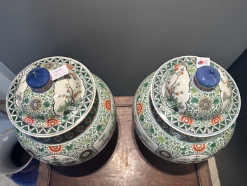 A pair of Chinese famille verte 'bird and flower' vases and covers, Kangxi mark, 19th C.
