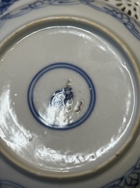 A Chinese blue and white reticulated double-walled cup and saucer, Kangxi