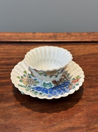 A Chinese famille rose relief-decorated cup and saucer, Yongzheng
