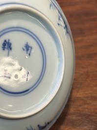 Four Chinese blue and white saucers and an 'erotic' cup, Kangxi