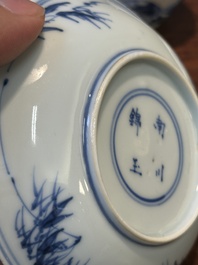 Four Chinese blue and white saucers and an 'erotic' cup, Kangxi