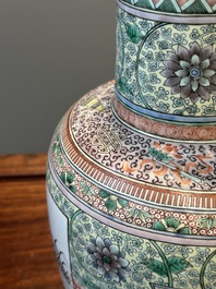 A Chinese famille verte covered vase and a bottle vase, 19th C.