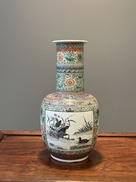 A Chinese famille verte covered vase and a bottle vase, 19th C.