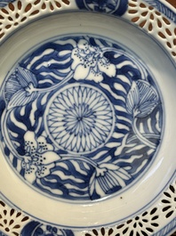 A Chinese blue and white reticulated double-walled cup and saucer, Kangxi