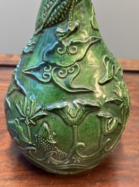 Two Chinese monochrome green-glazed stoneware 'dragon' vases and a kendi, Fujian kiln, late Ming