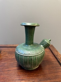 Two Chinese monochrome green-glazed stoneware 'dragon' vases and a kendi, Fujian kiln, late Ming