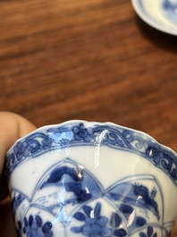 Four Chinese blue and white saucers and an 'erotic' cup, Kangxi