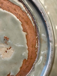 A Chinese Longquan celadon dish with floral anhua design, Ming