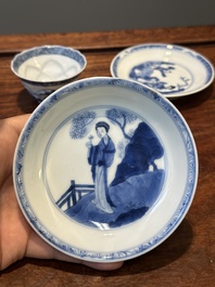 Four Chinese blue and white saucers and an 'erotic' cup, Kangxi
