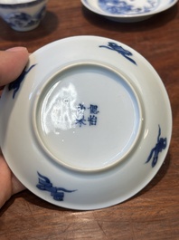 Four Chinese blue and white saucers and an 'erotic' cup, Kangxi