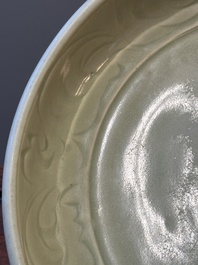 A Chinese Longquan celadon dish with floral anhua design, Ming
