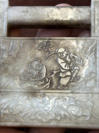 A Chinese white and russet jade lock-shaped plaque with inscription 'Huan Tian Xi Di 歡天喜地', Qing