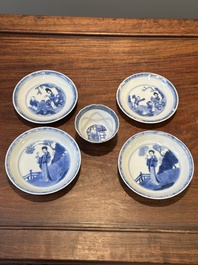 Four Chinese blue and white saucers and an 'erotic' cup, Kangxi