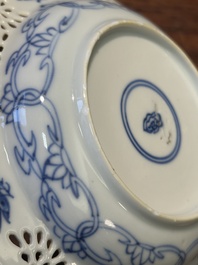 A Chinese blue and white reticulated double-walled cup and saucer, Kangxi