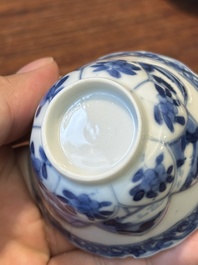 Four Chinese blue and white saucers and an 'erotic' cup, Kangxi