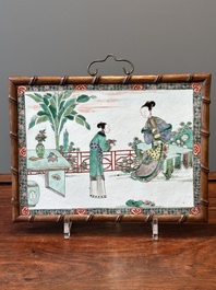 A rectangular Chinese famille verte plaque in a wooden faux bamboo frame, Kangxi