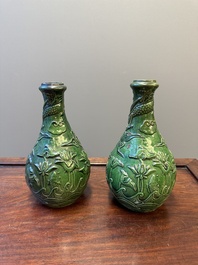 Two Chinese monochrome green-glazed stoneware 'dragon' vases and a kendi, Fujian kiln, late Ming