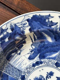 A Chinese blue and white dish with landscape and floral panels, Kangxi