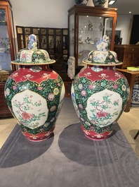 A pair of Chinese famille rose black-ground jars and covers with mountainous landscape design, Yongzheng