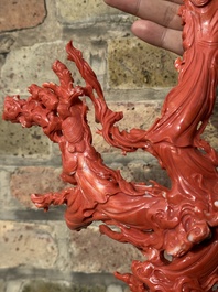 A large Chinese red coral group of female deities among clouds on wooden stand, 19/20th C.