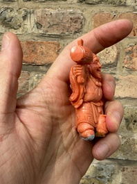 A set of seven Chinese red coral figures on wooden stand, 19/20th C.