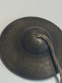 Four Tibetan bronze and wooden phurbas, a 'kapala' or skull-bowl, a pair of brass tingsha and two silver ornaments,  19th C.
