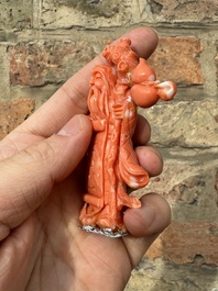 A set of seven Chinese red coral figures on wooden stand, 19/20th C.