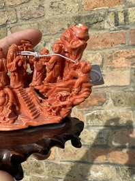A Chinese red coral 'Eight Immortals' group on wooden stand, 19/20th C.