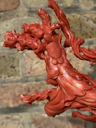 A large Chinese red coral group of female deities among clouds on wooden stand, 19/20th C.
