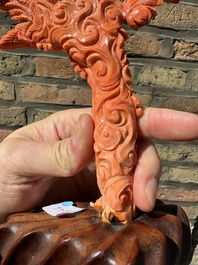 A Chinese red coral figure of Xiwangmu on wooden stand, 19/20th C.