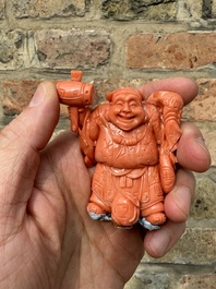 A set of seven Chinese red coral figures on wooden stand, 19/20th C.