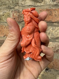 A set of seven Chinese red coral figures on wooden stand, 19/20th C.