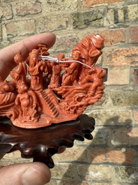 A Chinese red coral 'Eight Immortals' group on wooden stand, 19/20th C.