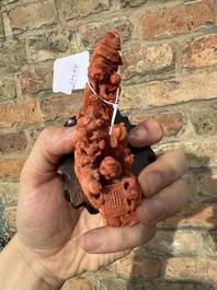 A Chinese red coral 'Eight Immortals' group on wooden stand, 19/20th C.