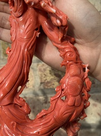A large Chinese red coral group of female deities among clouds on wooden stand, 19/20th C.
