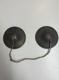 Four Tibetan bronze and wooden phurbas, a 'kapala' or skull-bowl, a pair of brass tingsha and two silver ornaments,  19th C.