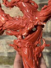 A large Chinese red coral group of female deities among clouds on wooden stand, 19/20th C.