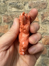 A set of seven Chinese red coral figures on wooden stand, 19/20th C.